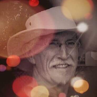 Vasu with a hat in a portrait photo with edited lens flares